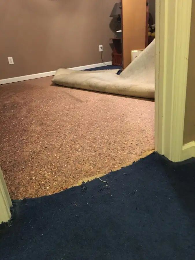Carpet pad removal revealing water damage during Drying & Dehumidification in Kaiminani